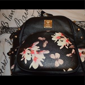 Black and floral studded backpack